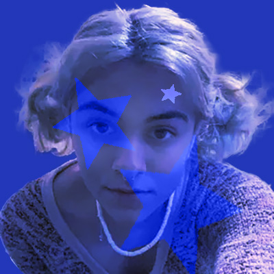 A selfie of a blonde teen girl with a slight blue filter over here. There are transparent stars on her face with a blue background. 